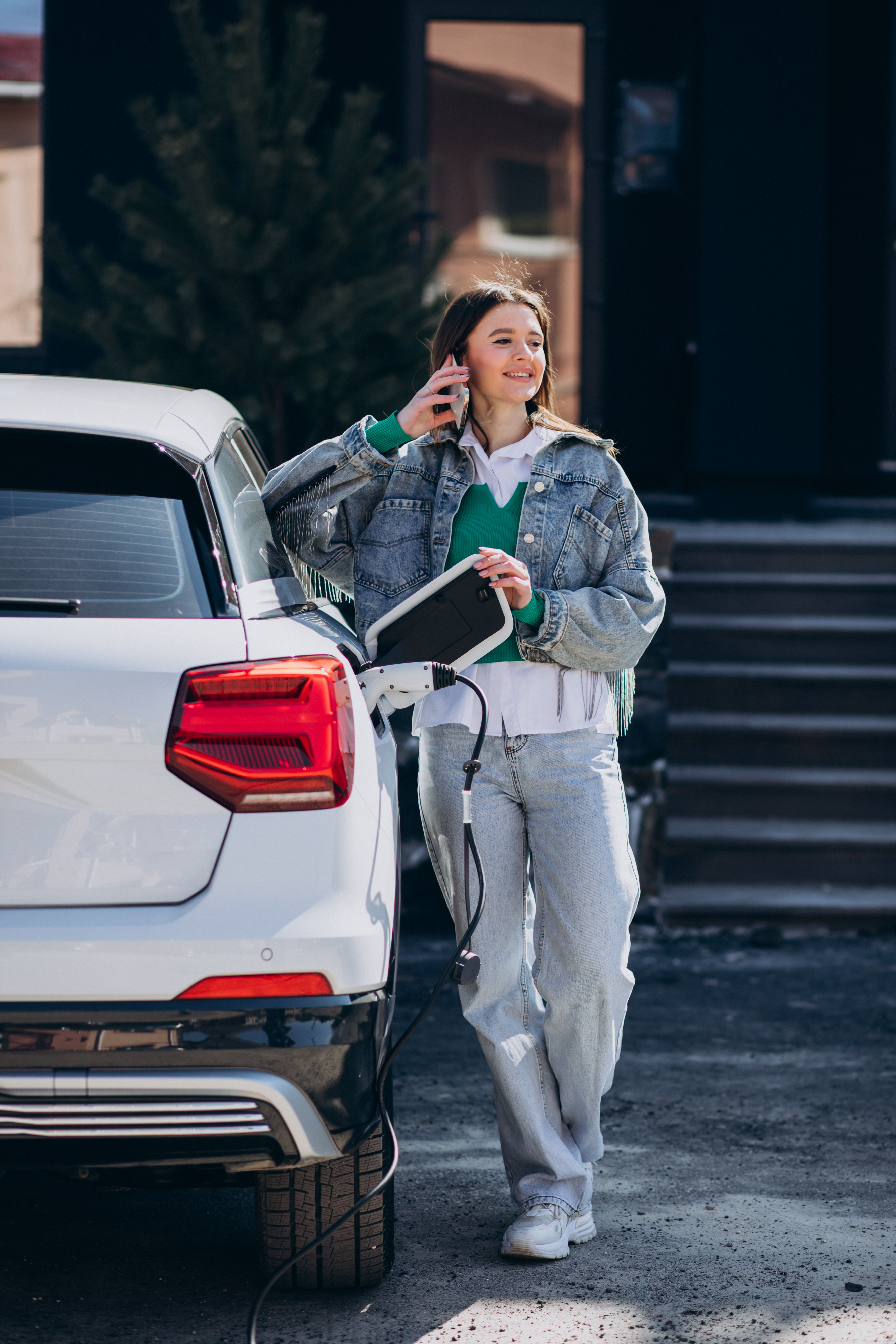 Driver connecting an electric vehicle to a charging point